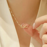 Model wearing dainty bamboo diamond pendant at collarbone